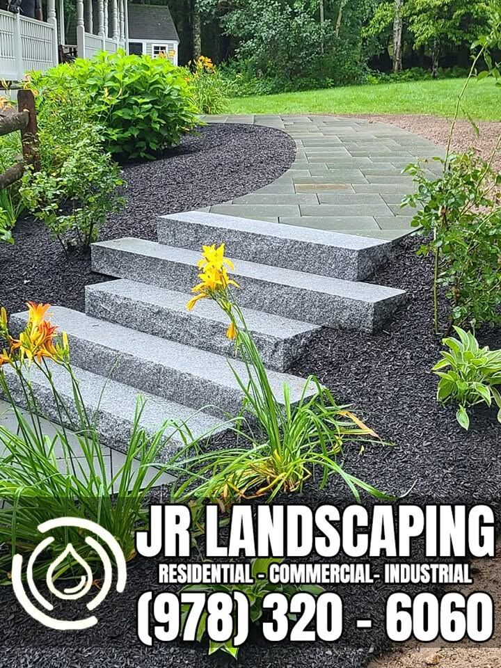 Granite and bluestone paver steps flanked by daylilies