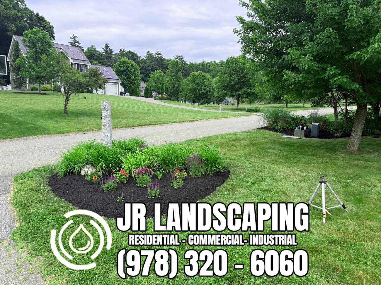 Kidney-shaped mulch-bed island with ornamental grasses and perennials